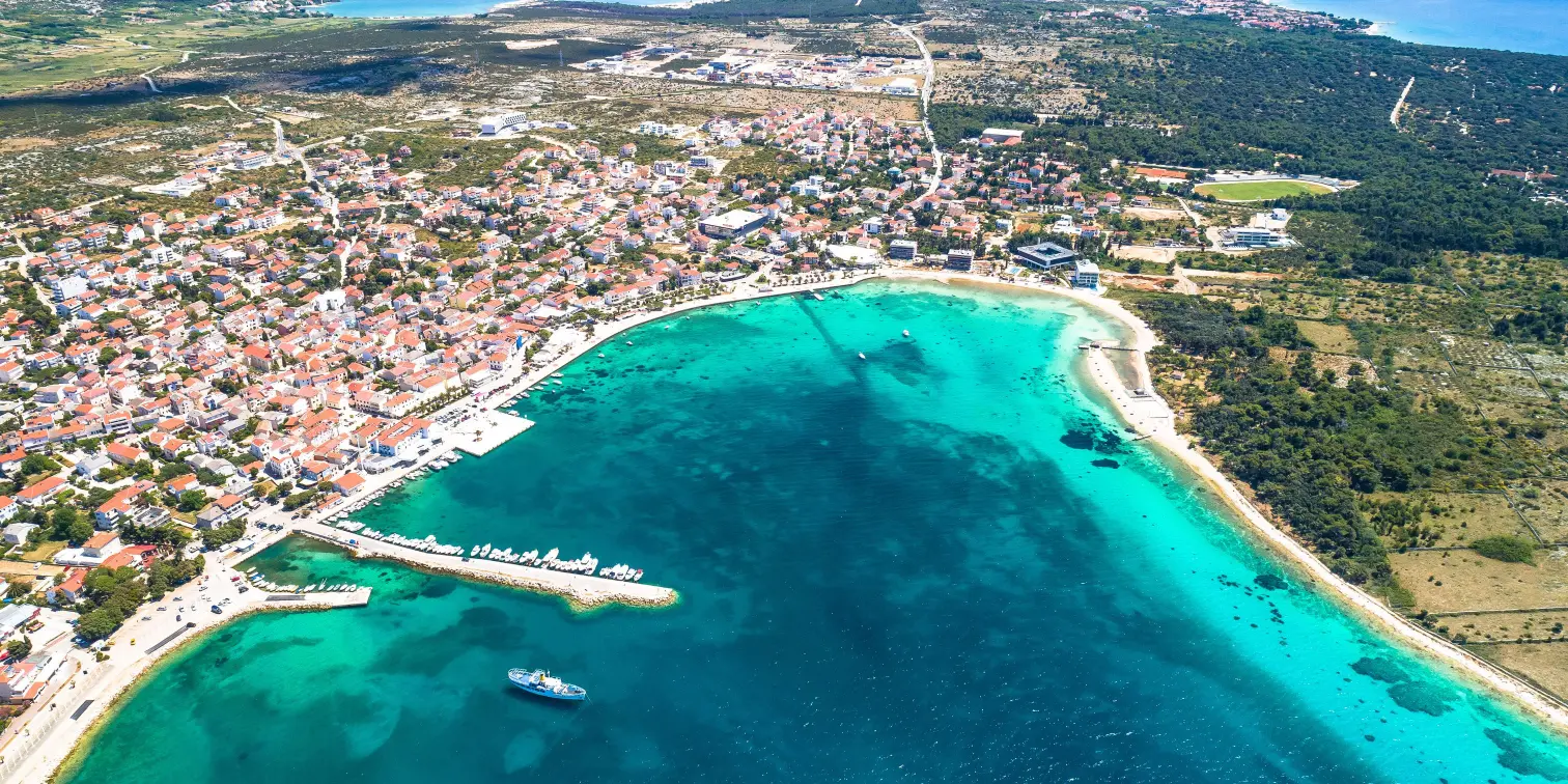 Novalja, Pag island. Idyllic beach and turquoise sea aerial view in town of Novalja